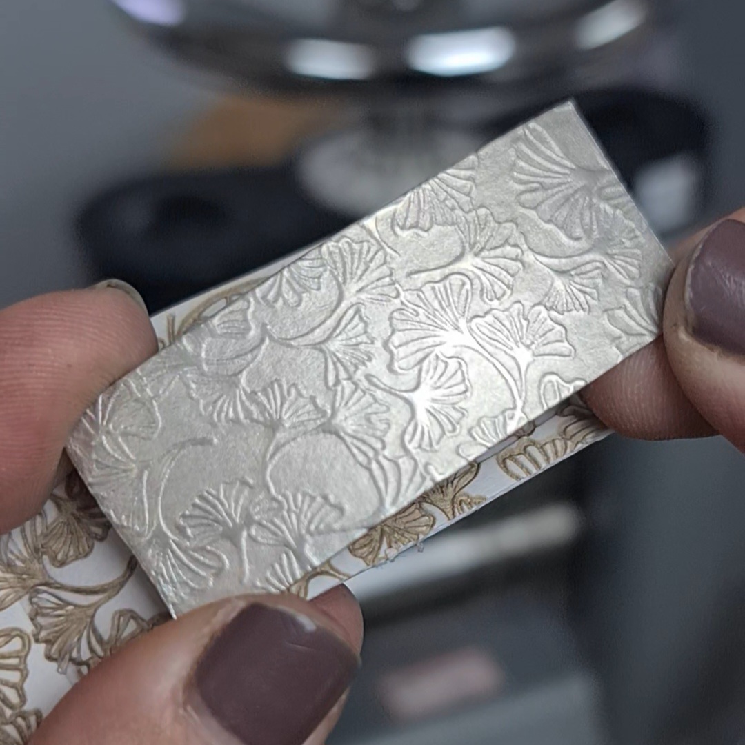 image shows the beautiful pattern of Ginkgo leaves embossed into the silver sheet